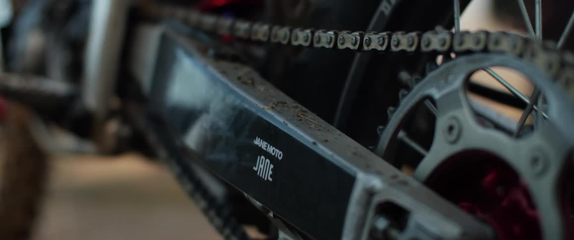 A close up view of a chain on a dirt bike