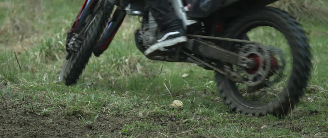 A person is riding a bike in a grassland field