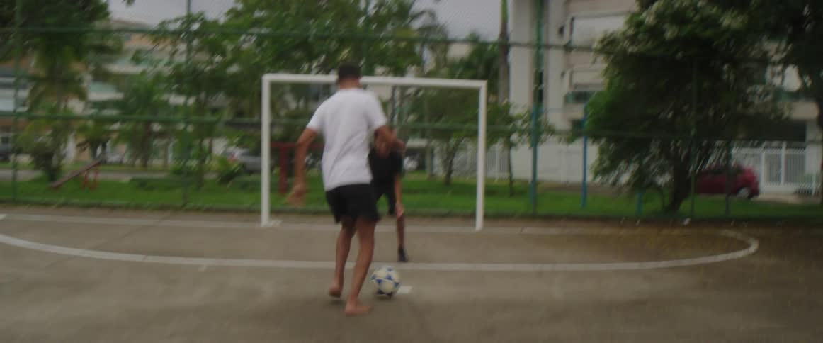 Two people are playing soccer outdoors in spring