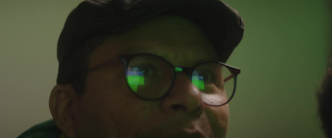 A man shakes his head and throws his arms up in frustration while watching a soccer match
