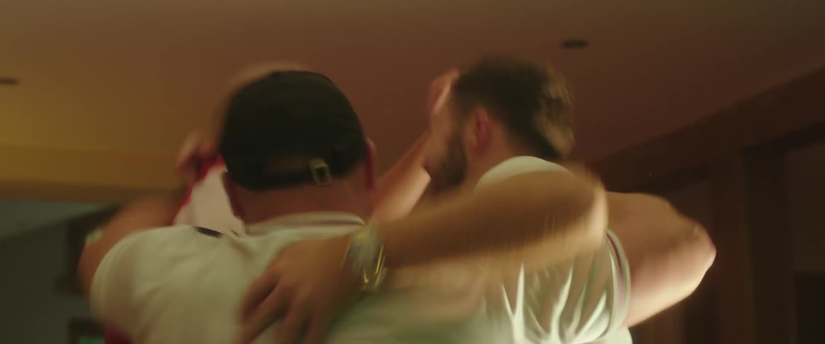 Three man watching football match on television celebrating the goal in the living room at home