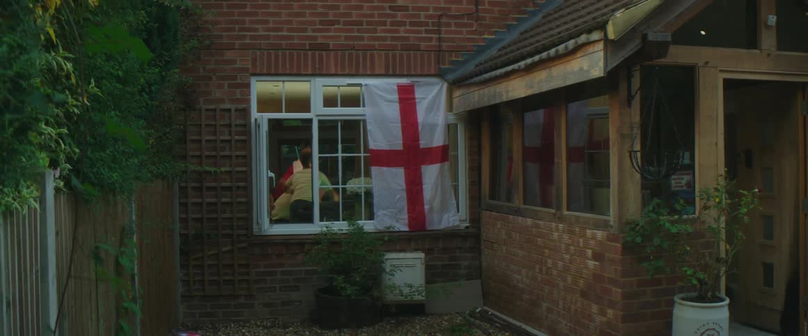 People cheer and jump around inside the house