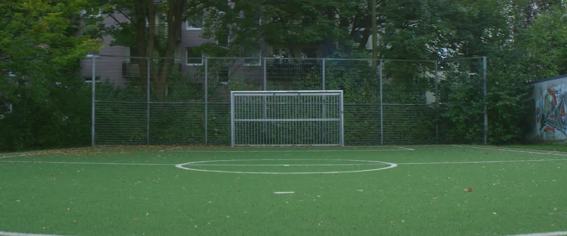 An empty soccer field is displayed in spring