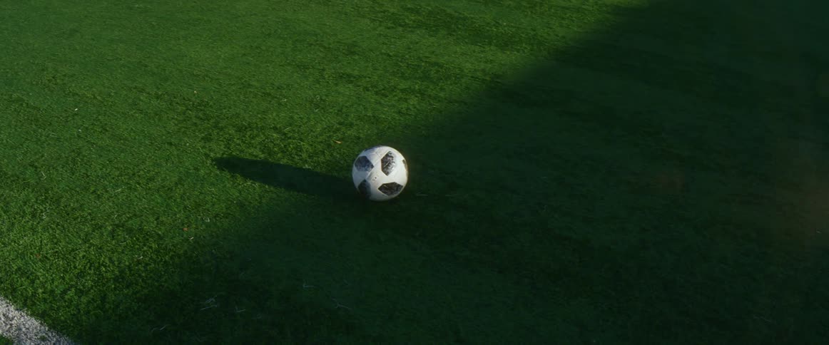 A soccer ball is sitting on a soccer field