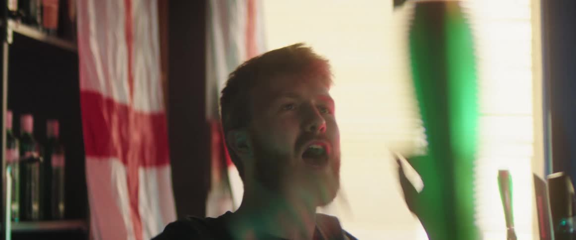 A man that is standing in a room cheering