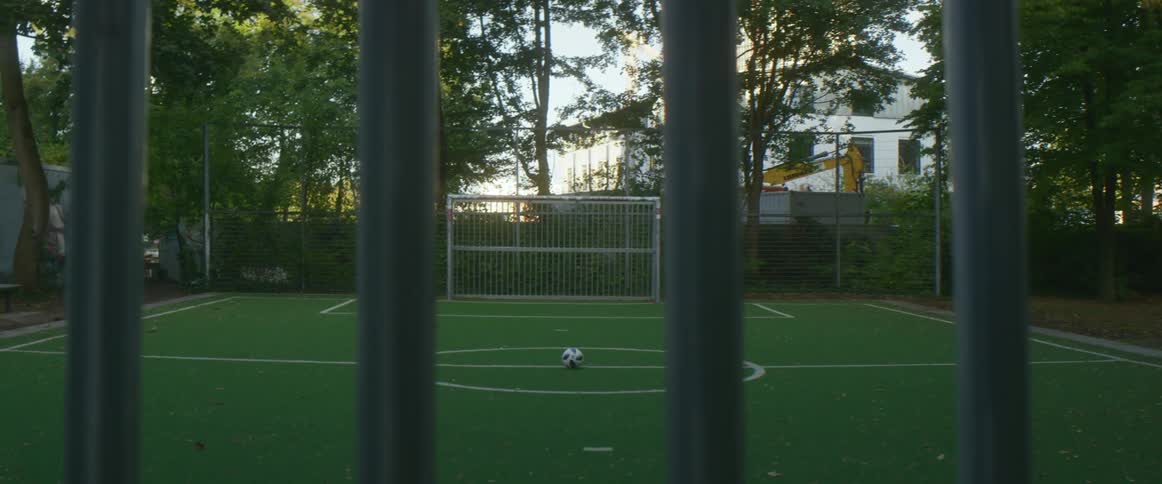 A soccer ball is placed on the middle of a field