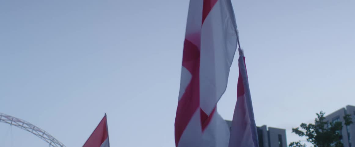 Flags for different countries fly outside buildings downtown