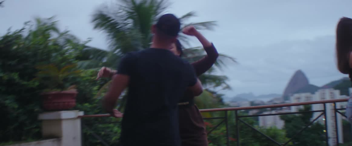 A crowd of people are dancing on a balcony