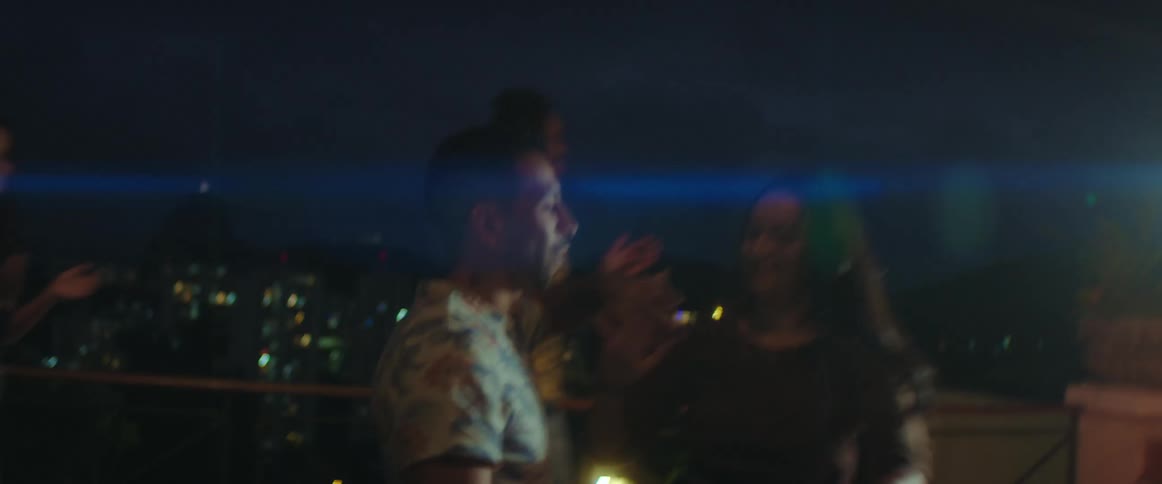 People are dancing together at a night club outdoors