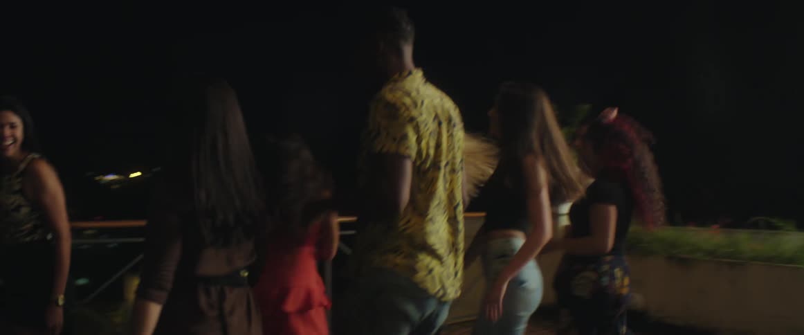 Group of friends dancing a group choreography outdoors at night