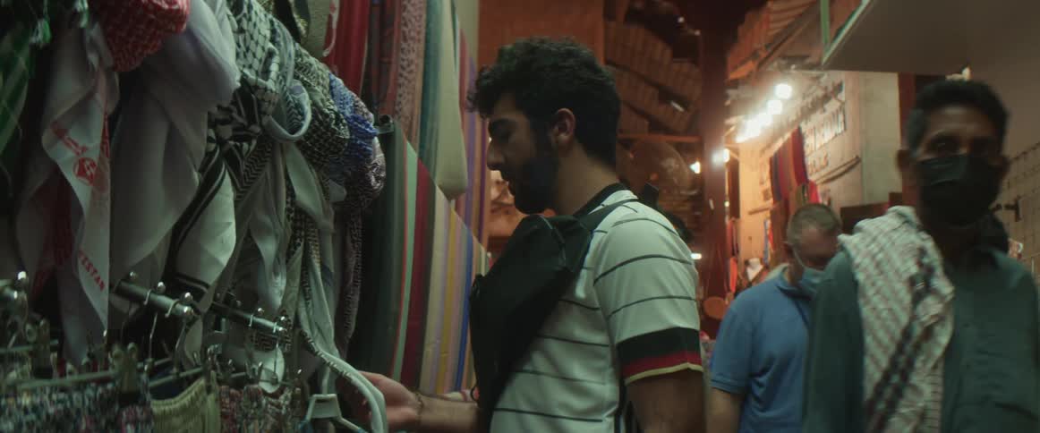 A person looking around at fabric in a store