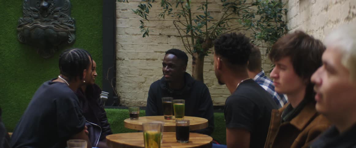 A group of friends are having drinks at a restaurant together