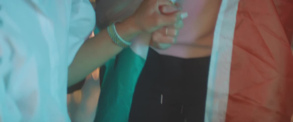 Two friends are holding hands and celebrating together