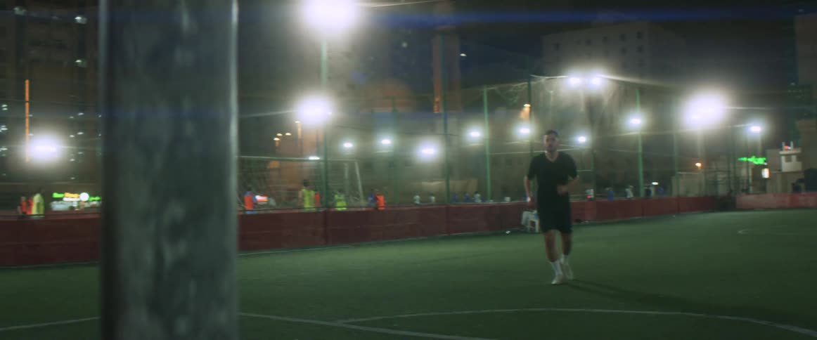 A male soccer player kicking the soccer ball on a soccer field