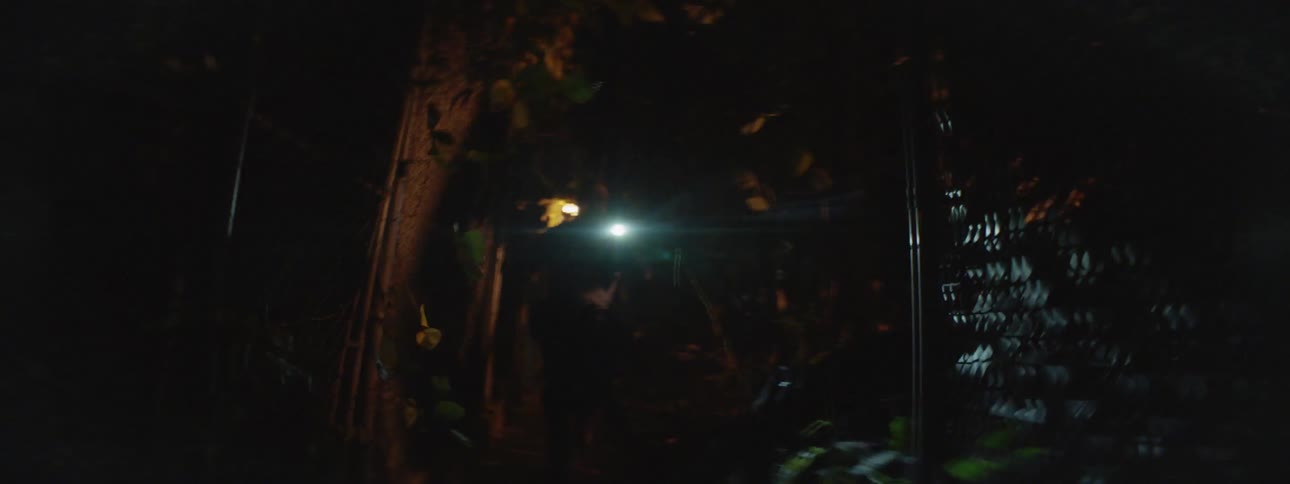 A person is running down a dark alley at night