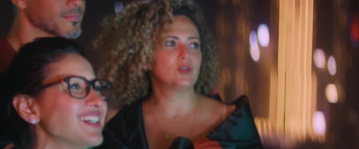 A group of people outside at night talking