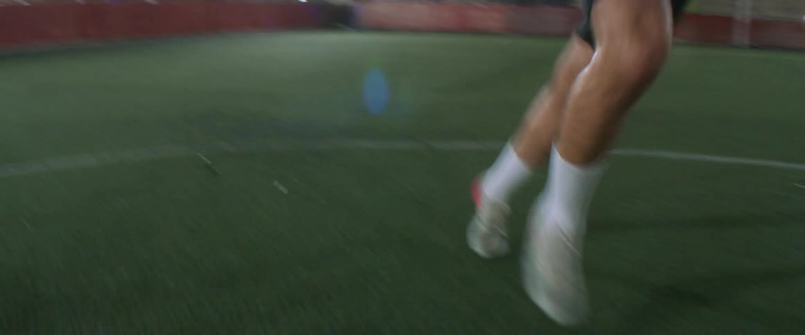 A man kicking a soccer ball outdoors