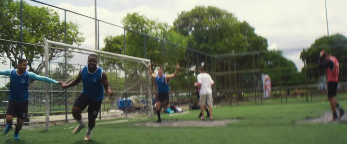 A group of people are playing soccer against each other