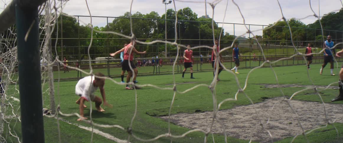 A group of men are playing soccer together in spring
