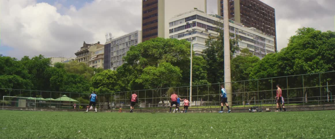 People are playing soccer on the grass field