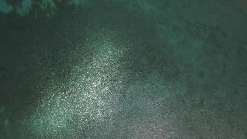 Birds eye view of ocean water at midday