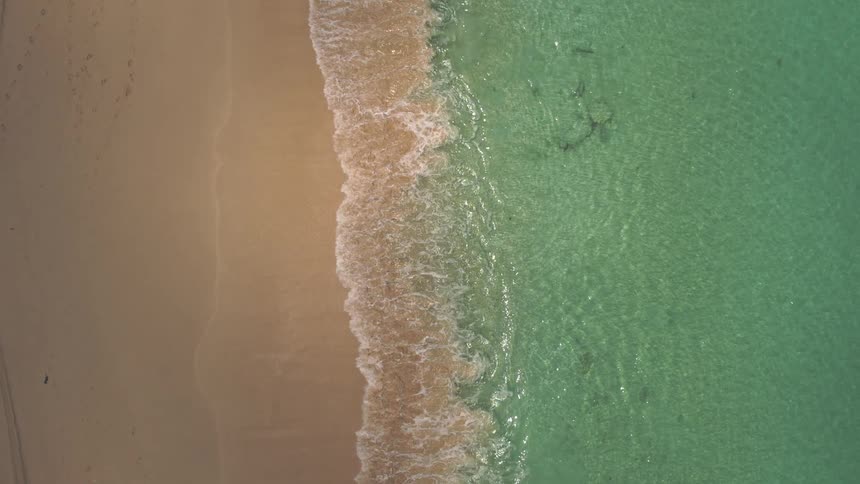 The blue water is on the sand