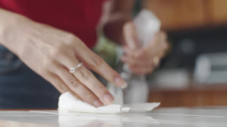 Woman cleaning the countertop in the kitchen
