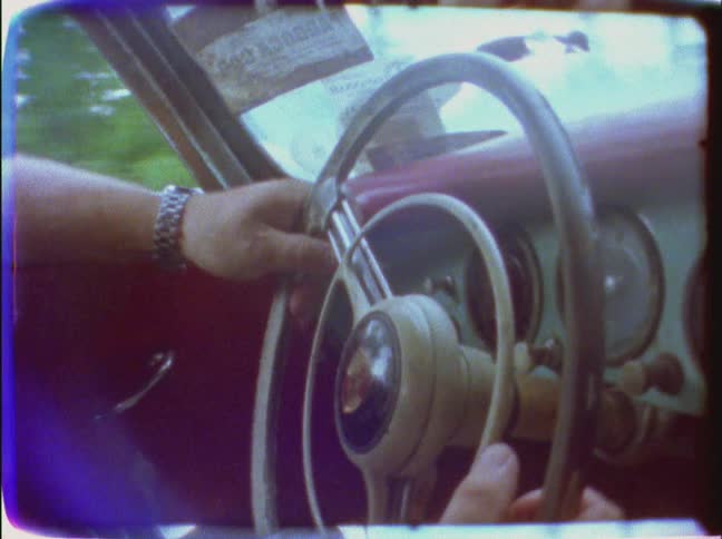 Close up of a person driving turning a wheel