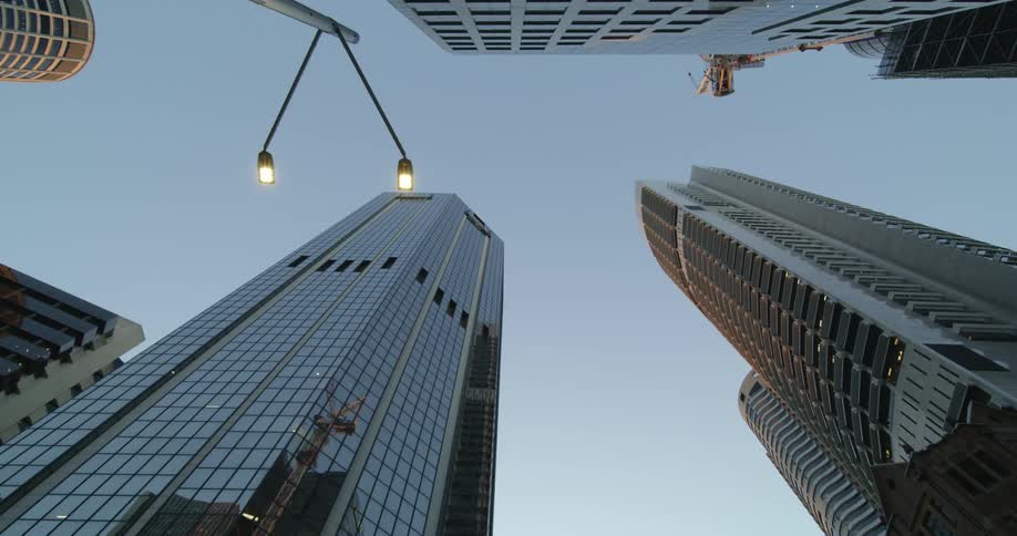 Glass on skyscraper in tower block reflects opposing building