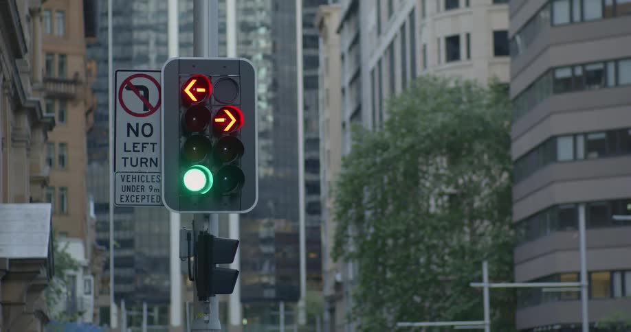 A traffic light is turning green in a downtown city