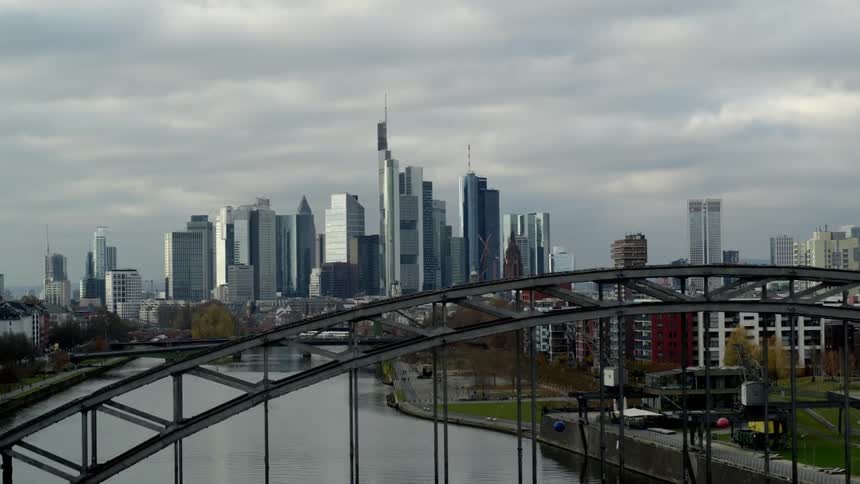 Aerial view of bridges over a river near the city skyline
