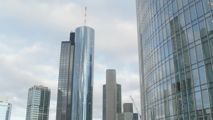 High rise office buildings in a city with a construction crane in the background