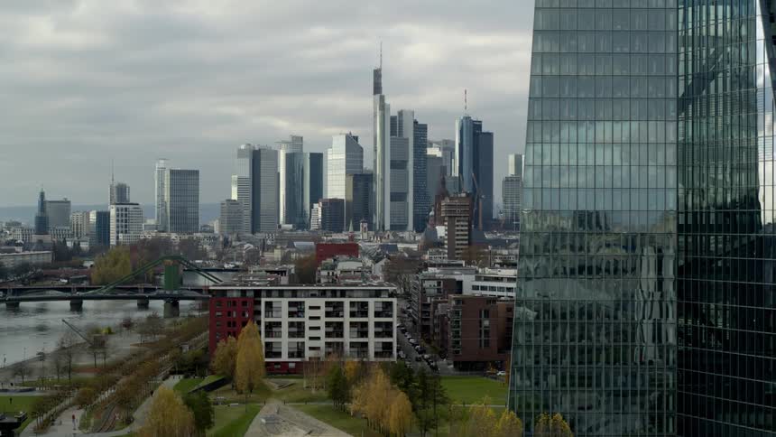 Skyscrapers loom over a metropolis on a cloudy day