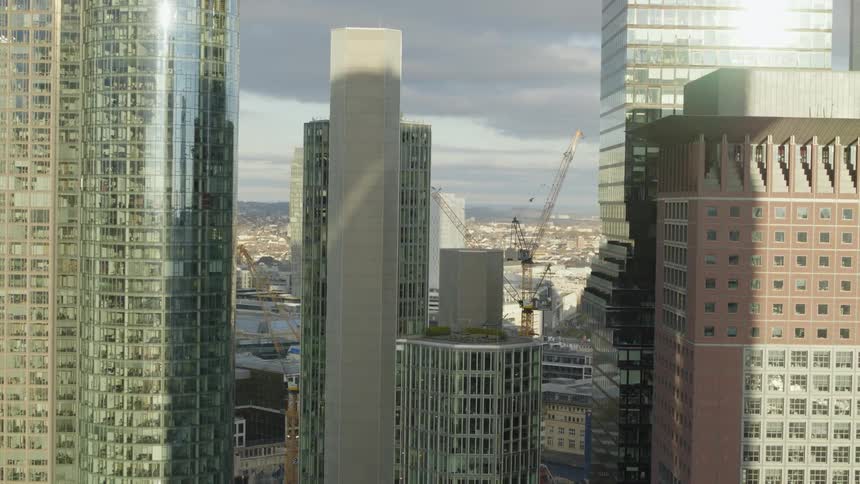 Aerial view of high rise buildings with construction cranes in the city