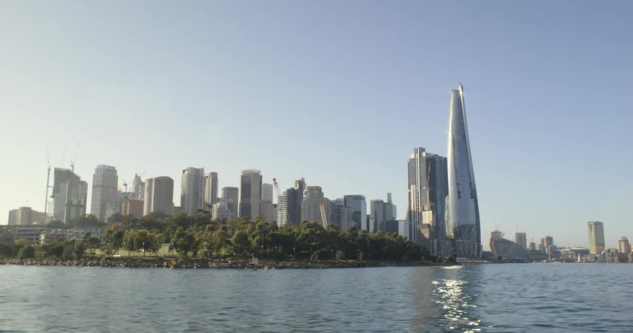 The view of a city skyline is near a body of water