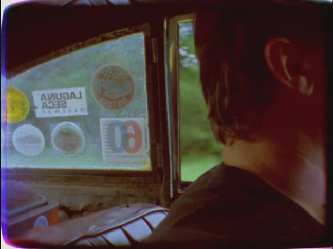 A man drives an old vehicle
