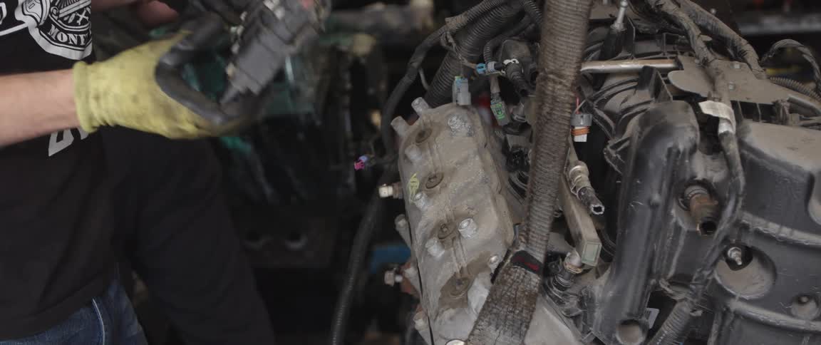 Mechanic disassembles engine at the garage
