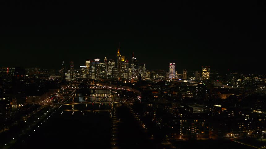A big city with tall skyscrapers lit up at night