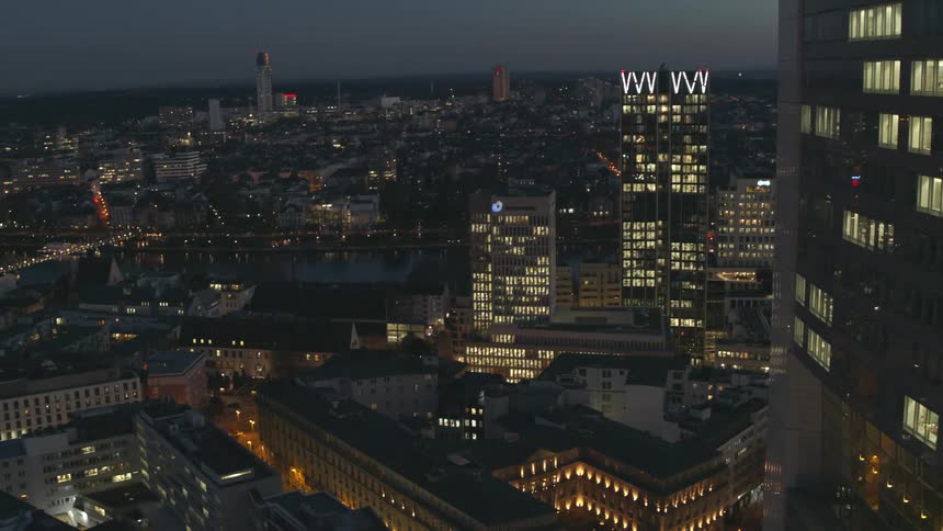 Aerial view of buildings in a downtown city is displayed at night