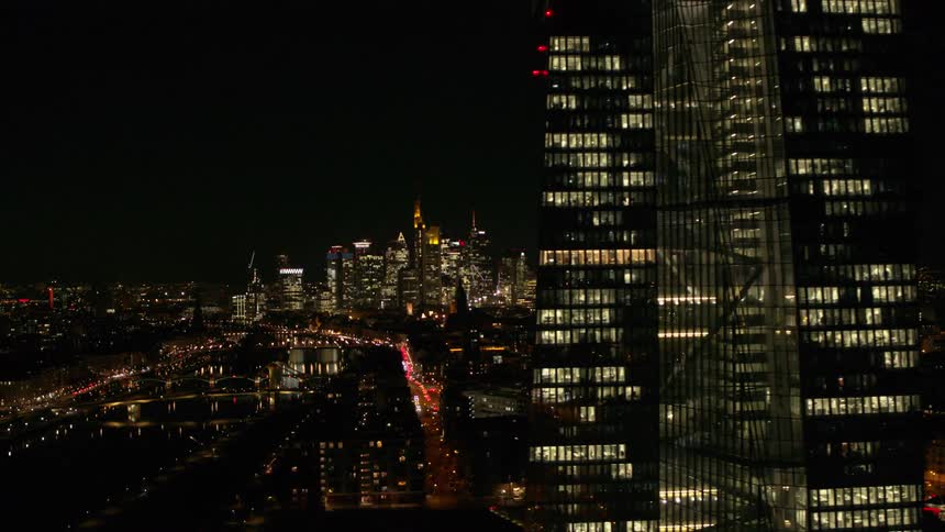 Aerial view of buildings in a downtown city at night is displayed