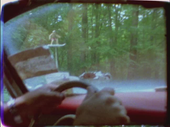 A person drives their car down a winding road