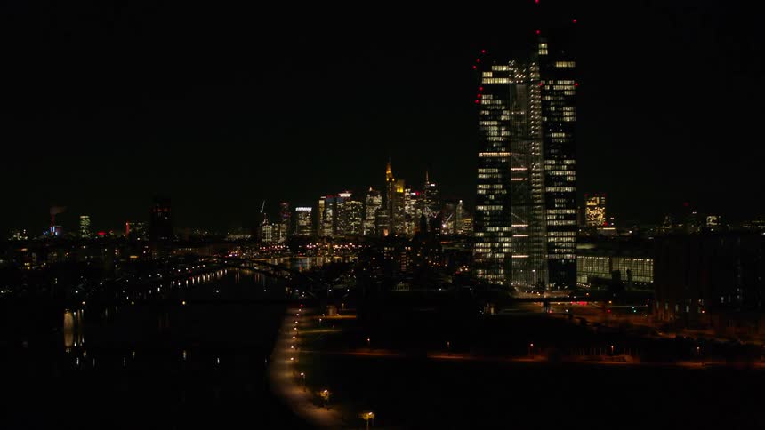 A tall building in a metropolis at night