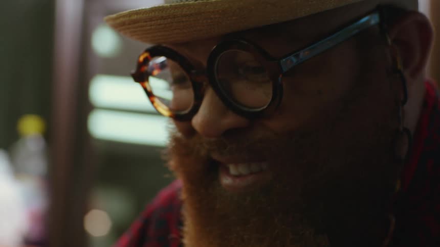 Close up of a mans face indoors as he smiles