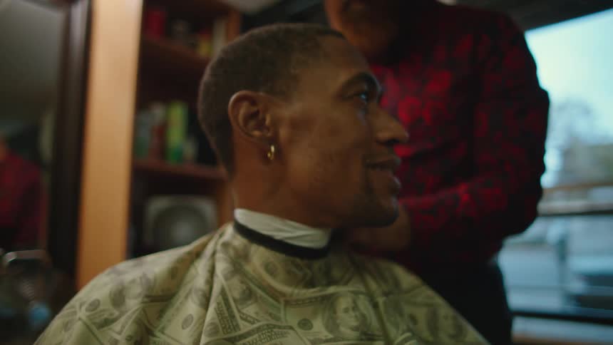 Employee cutting a clients hair at the barbershop