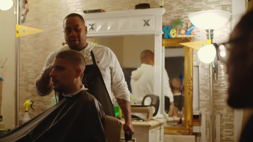 A man that is cutting a persons hair
