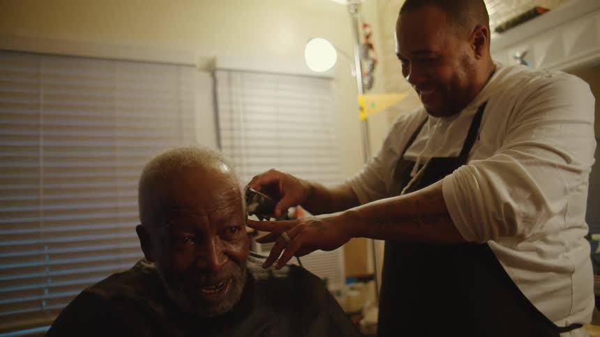 A man is getting a haircut at a barber shop