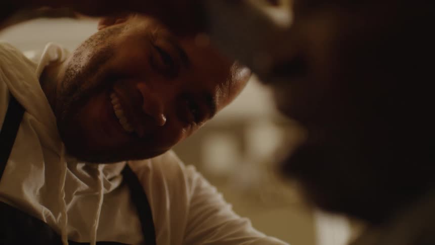A barber working on a mans hair