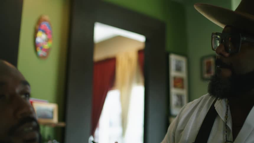 A man is at a barber shop during the daytime