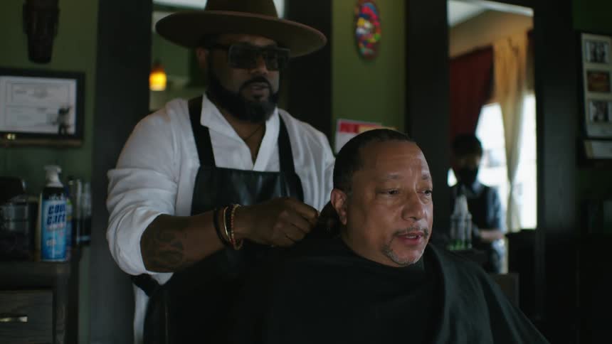 A man is getting ready to get his haircut at a barber shop