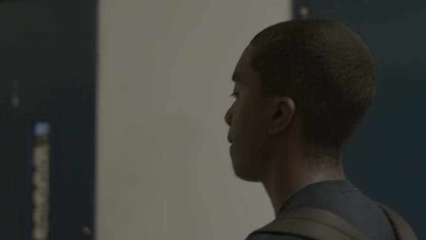 A boy walks down a school hall